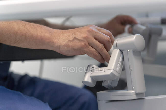 Close-up shot of surgeon working with robot in operation room — Stock Photo