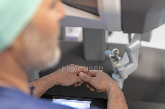 Close-up shot of surgeon working with robot in operation room — Stock Photo