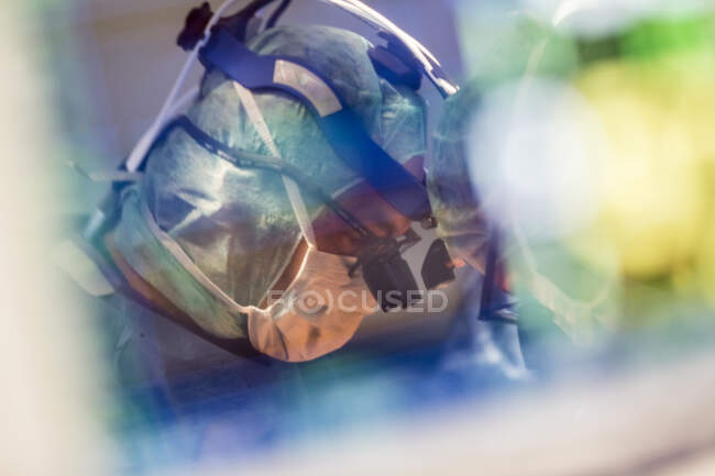 Close-up shot of surgeon with binoculars at work — Stock Photo