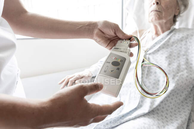 Senior woman checking blood pressure from patient — Stock Photo
