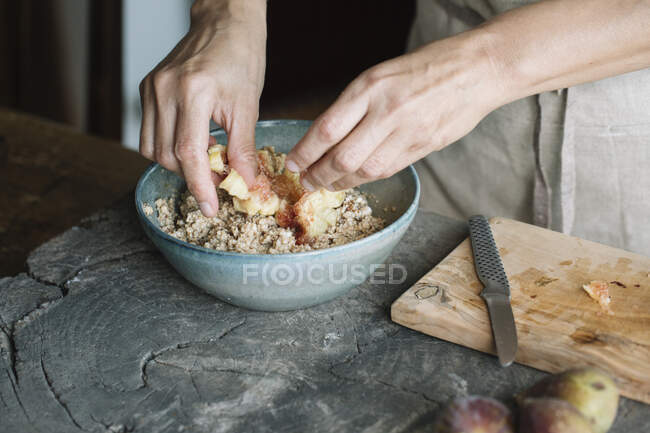 Close up of woman cooking cake with figs — Stock Photo