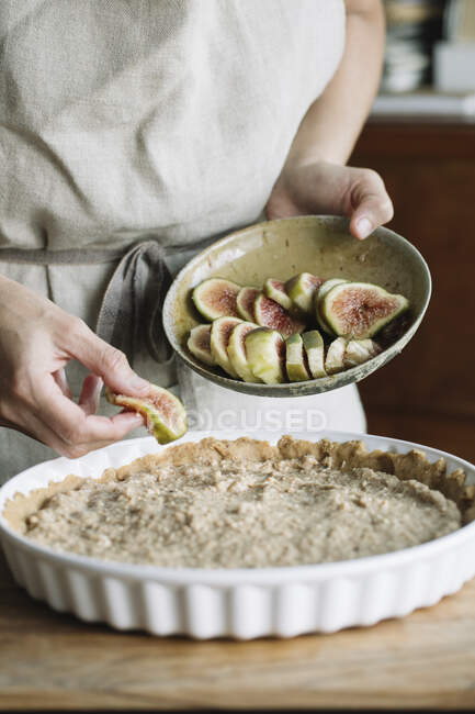Close up of woman cooking cake with figs — Stock Photo