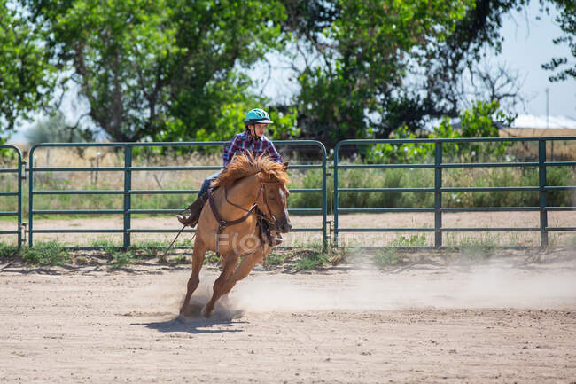 Tween menina correndo seu cavalo em uma arena — Fotografia de Stock