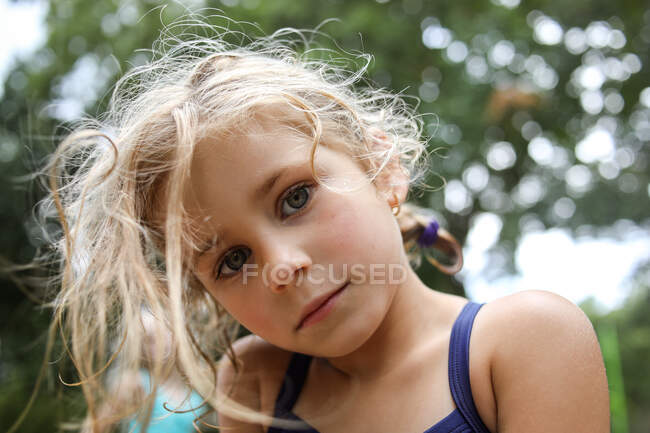 Portrait of girl looking at camera with serious look on face close up — Stock Photo