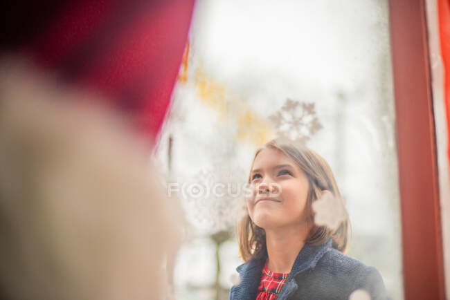 Chica joven ver a Santa en la ventana - foto de stock