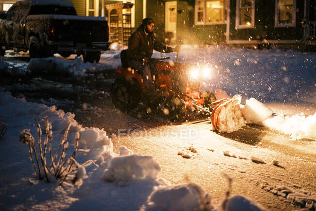 Millennial mechanic on vintage restored tractor plowing snowy driveway — Stock Photo