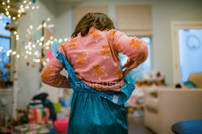 Little girl playing dress up with christmas gift princess outfit — Stock Photo