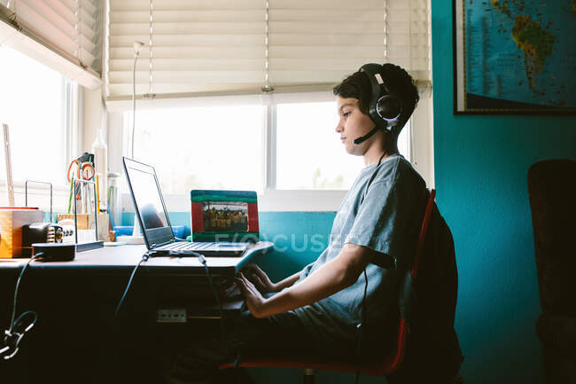 Boy Stares At The Screen Of His Laptop During A Zoom Class — Stock Photo