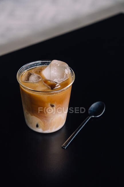 Iced coffee with ice cream on a wooden background — Stock Photo
