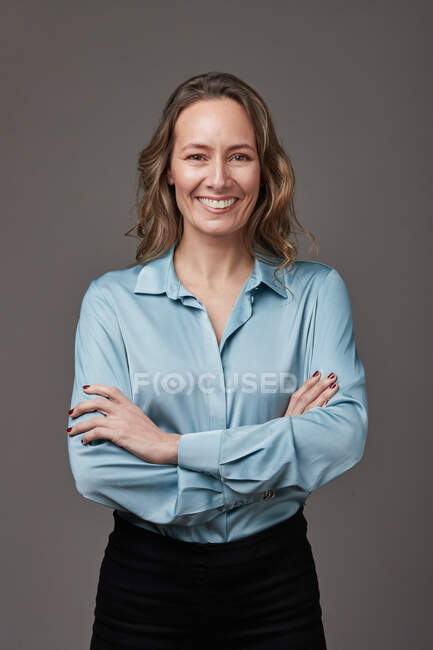 Retrato en estudio de mujer empresaria sobre fondo gris. - foto de stock