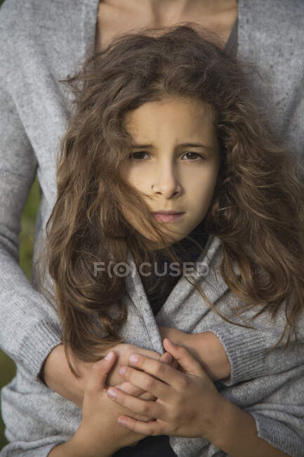 Close-up girl in the arms of her mother. — Stock Photo