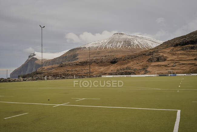 Soccer field turf with mountains behind in the Faroe Islands — Stock Photo