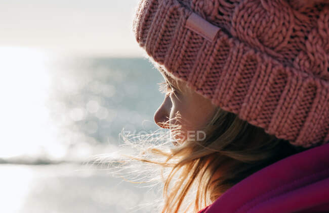 Close up of a young girl looking out to see on a beautiful sunny day — Stock Photo