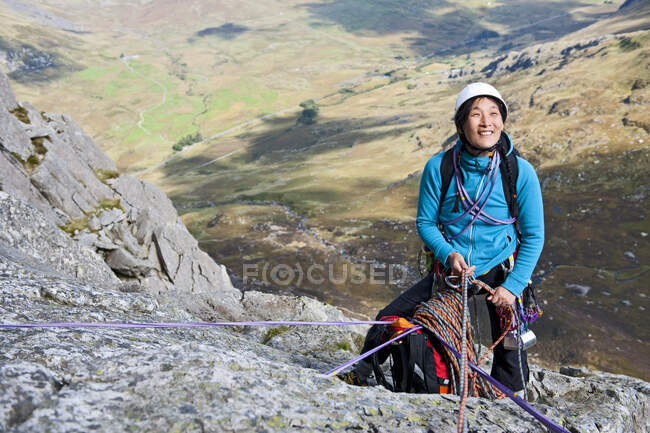 Female rock climber at belay anchor point on Tryfan in North Wales — Stock Photo
