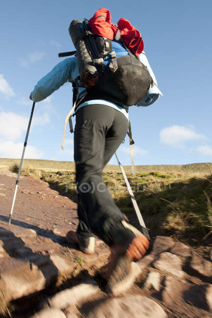 Female hiker walking up towards Pen Y Fan in Wales — Stock Photo
