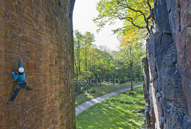 Woman climbing up on man made viaduct in Sheffield — Stock Photo