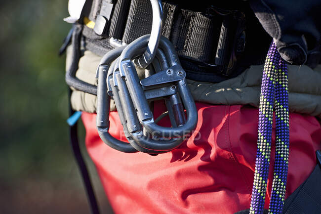 Steel karabiners hanging from a safety harness — Stock Photo