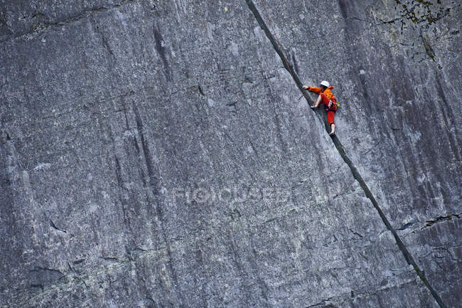 Frau klettert im Schieferbruch in Nordwales steile Felswand hinauf — Stockfoto