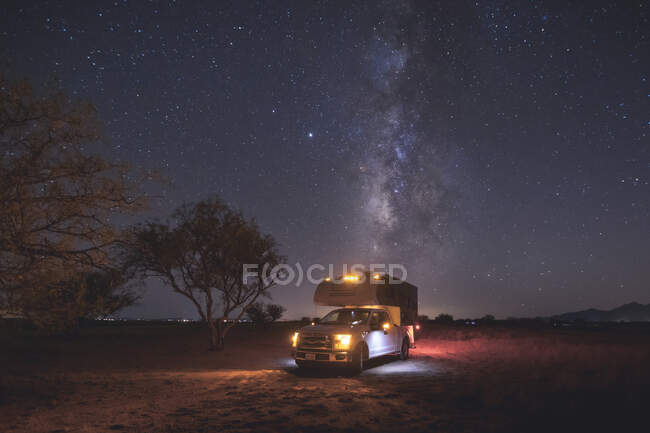 A beautiful sunset in the night sky with milky way, stars and trees — Stock Photo
