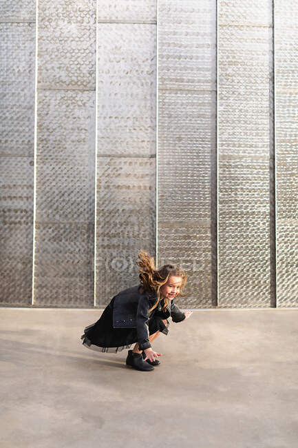 Portrait of a girl in a black suit, and brown clothes on a wall background — Stock Photo