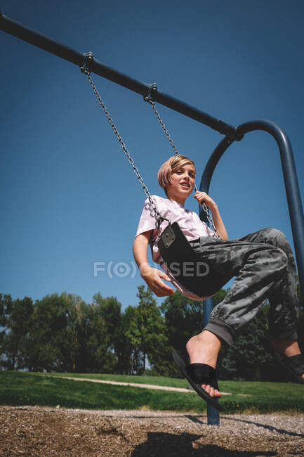Happy Boy on a Swing on a Sunny Afternoon — Stock Photo