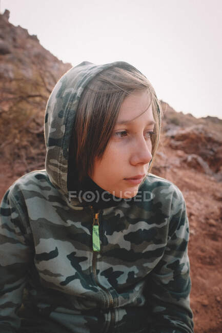 Close up of Boy in a Camo Hoodie in the Desert. — Stock Photo
