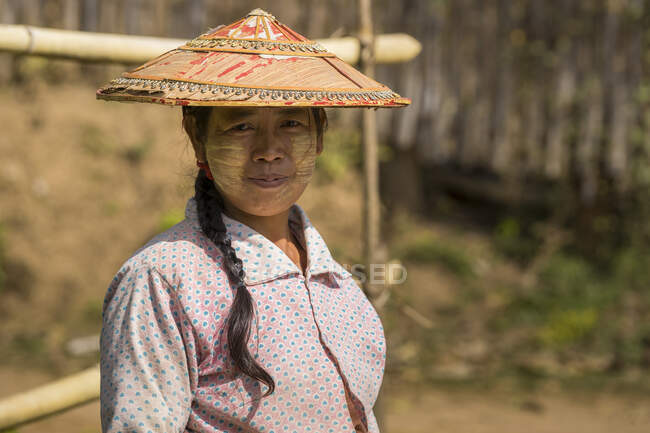 Retrato de jovem mulher olhando para a câmera em pequena aldeia perto — Fotografia de Stock