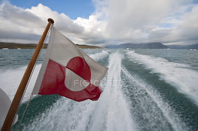 Greenlandic flag on the back of a speedboat — Stock Photo