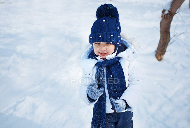 Cute girl in a winter forest — Stock Photo