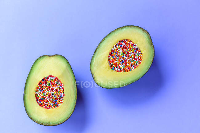 Fresh avocado stuffed with Easter sprinkle and pastry topping — Stock Photo