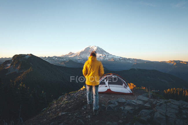 View of a  woman and camping tent on a background of mountains and the moon — Stock Photo