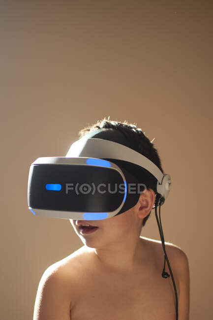 Young boy 9-10 years old playing virtual reality game at home — Stock Photo