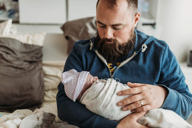 Father holding newborn baby boy right after birth — Stock Photo