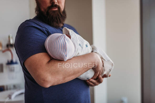 Newborn baby boy being held by father  in birthing center — Stock Photo