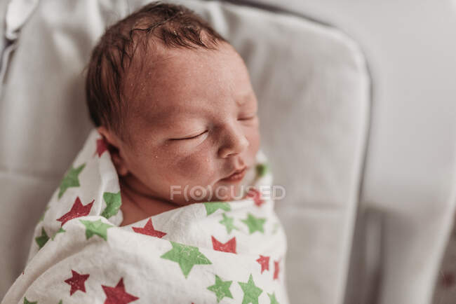 Side angle of newborn baby boy swaddled in birthing center — Stock Photo