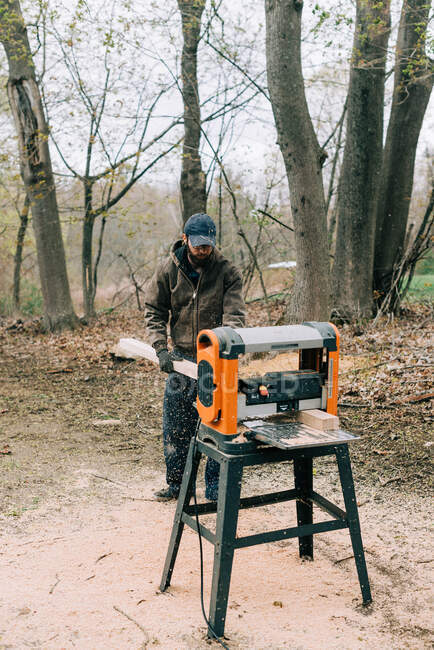 Man working with planer etc — Stock Photo