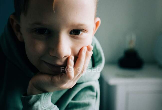 Close up portrait of an 8 year old boy looking right at the camera — Stock Photo