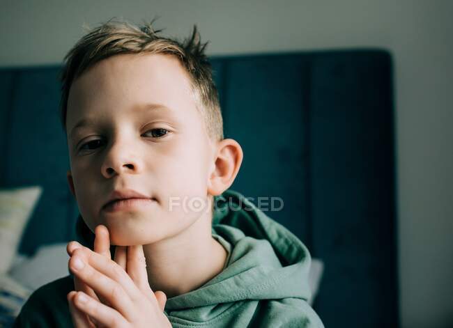 Close up portrait of handsome 8 year old blonde boy looking curious — Stock Photo