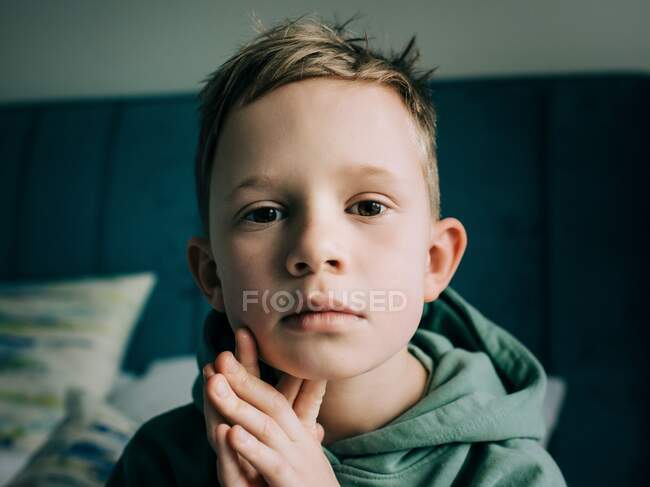 Close up portrait of a 8 year old handsome blonde boy starring — Stock Photo
