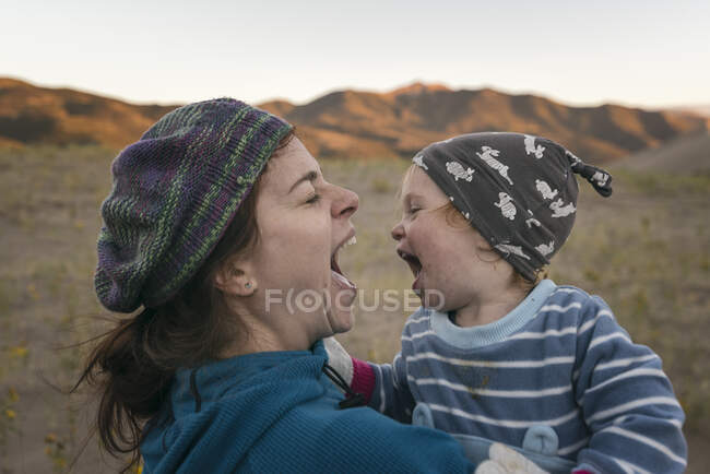 Mother and daughter having fun in the desert — Stock Photo
