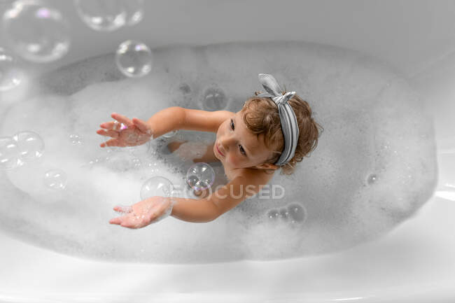 Cute little girl taking bath — Stock Photo