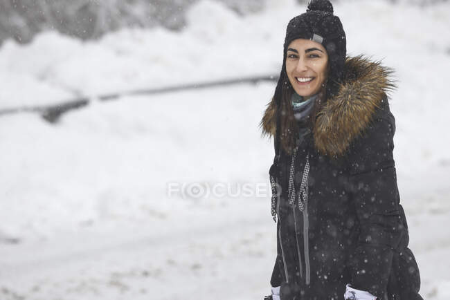 Woman with snow cap smiling — Stock Photo