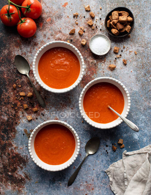 Tomato soup in plates on gray background. top view. — Stock Photo
