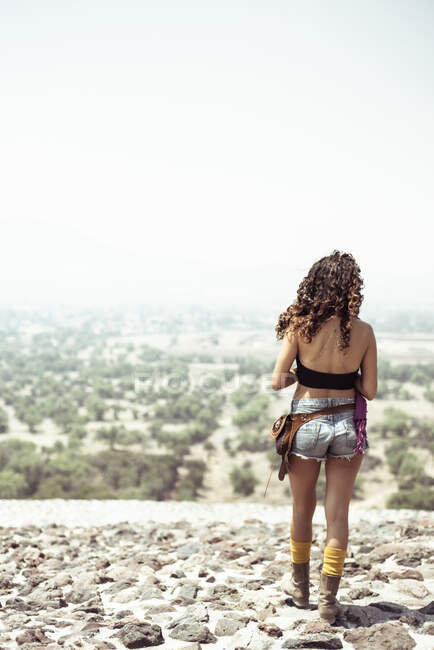 Young fit Mexican woman on misty dry ancient lookout — Stock Photo