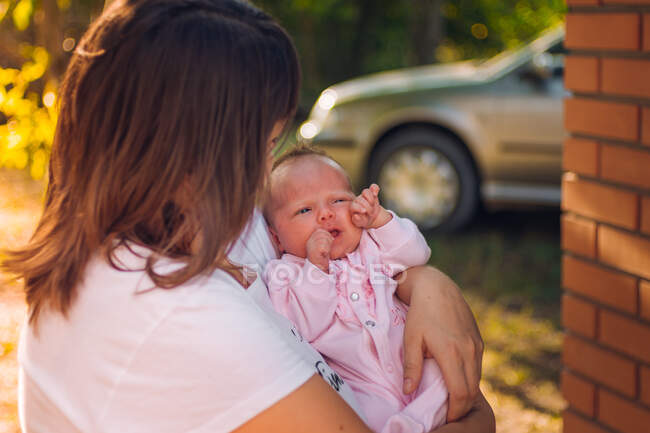 Foto de una madre sosteniendo cerca a su hija recién nacida - foto de stock