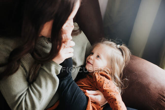 Beautiful young mother and her daughter having fun — Stock Photo