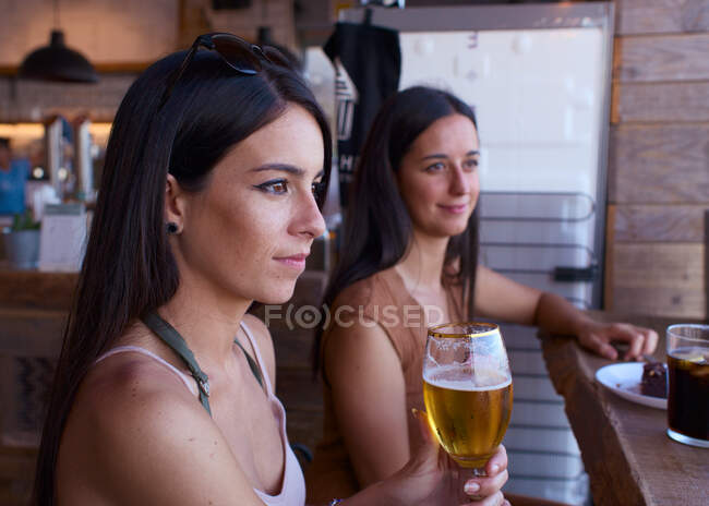 Due amici hanno birra e bibite analcoliche in un bar — Foto stock