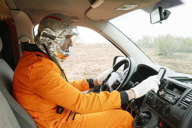 Man dressed as an astronaut using GPS — Stock Photo