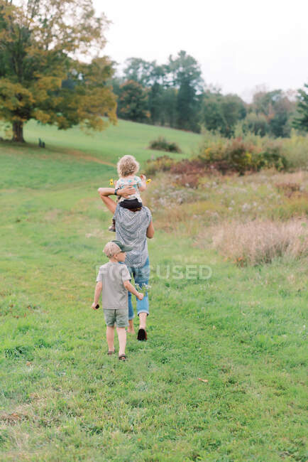 Two little kids and their grandmother on a nature walk in New England — Stock Photo