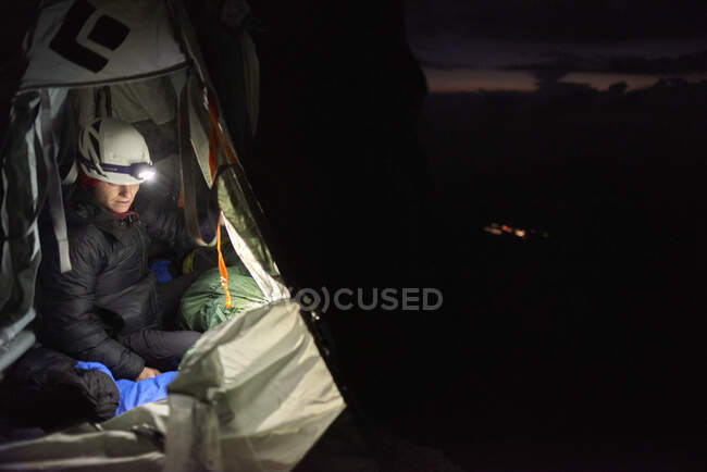 Female climber on a portaledge at night, Eiger North Face — Stock Photo
